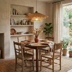 A table set for a meal sits beneath this Clérachic pendant, its light reaching open shelving stacked with pottery.