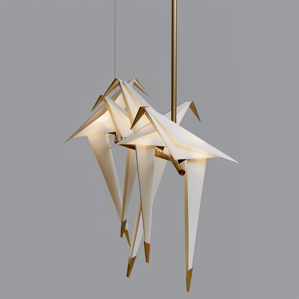 Bird chandelier with gold frame and birds over a table
