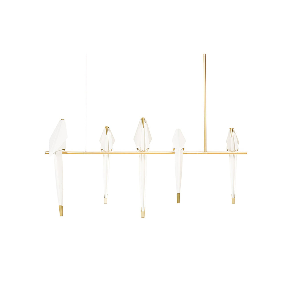 Bird chandelier glowing warmly above a styled dining table