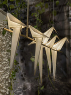 Bird chandelier with acrylic birds glowing along a gold branch