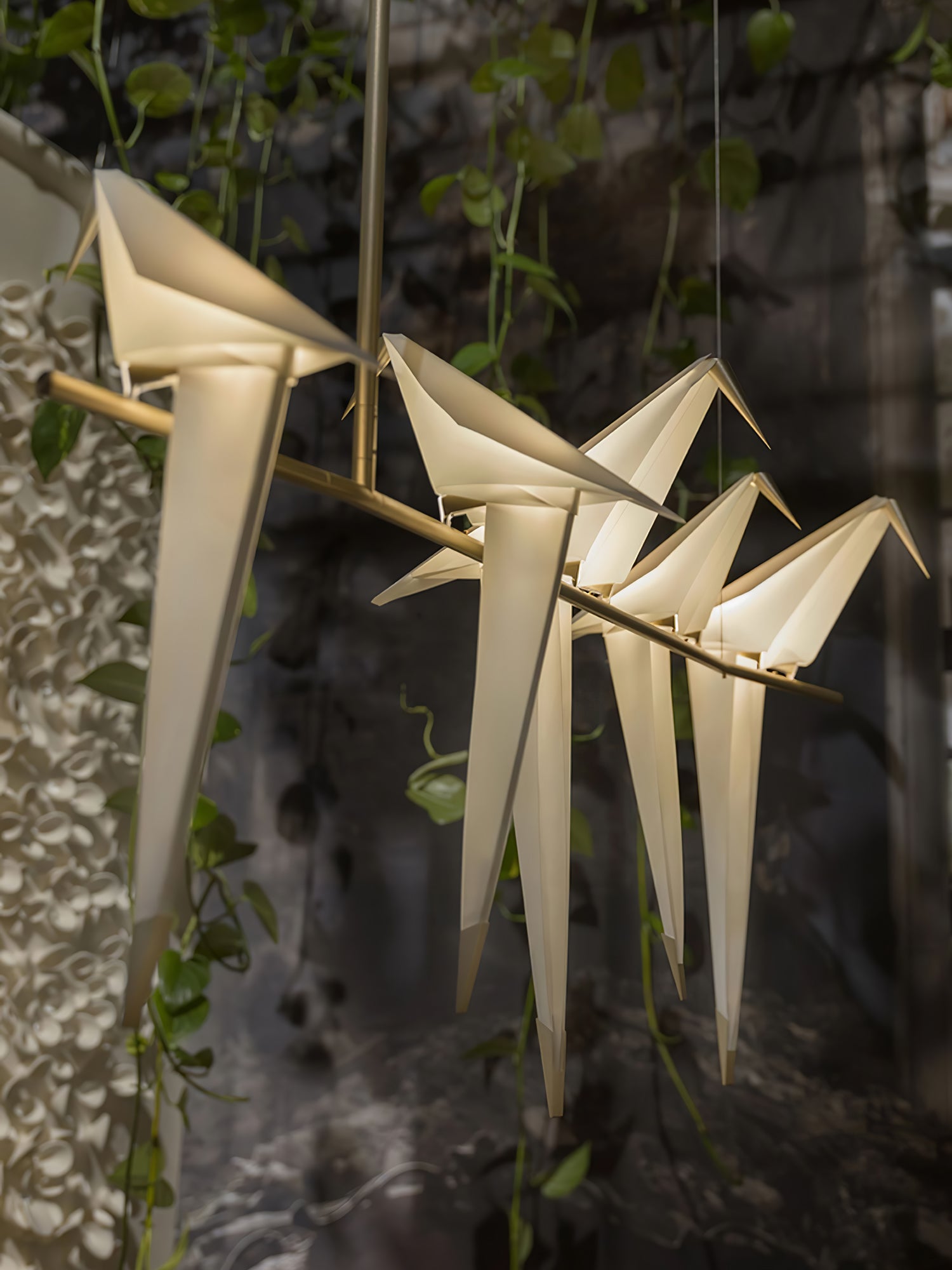 Bird chandelier with acrylic birds glowing along a gold branch