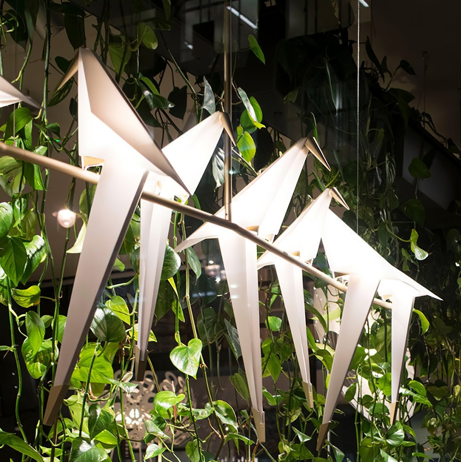 Bird chandelier with gold branch frame and soft white glow