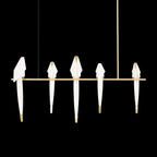 Bird chandelier close view of acrylic bird and gold branch