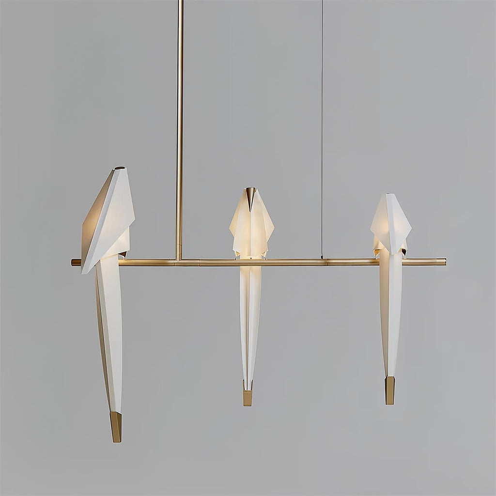 Bird chandelier glowing gently above a seating area