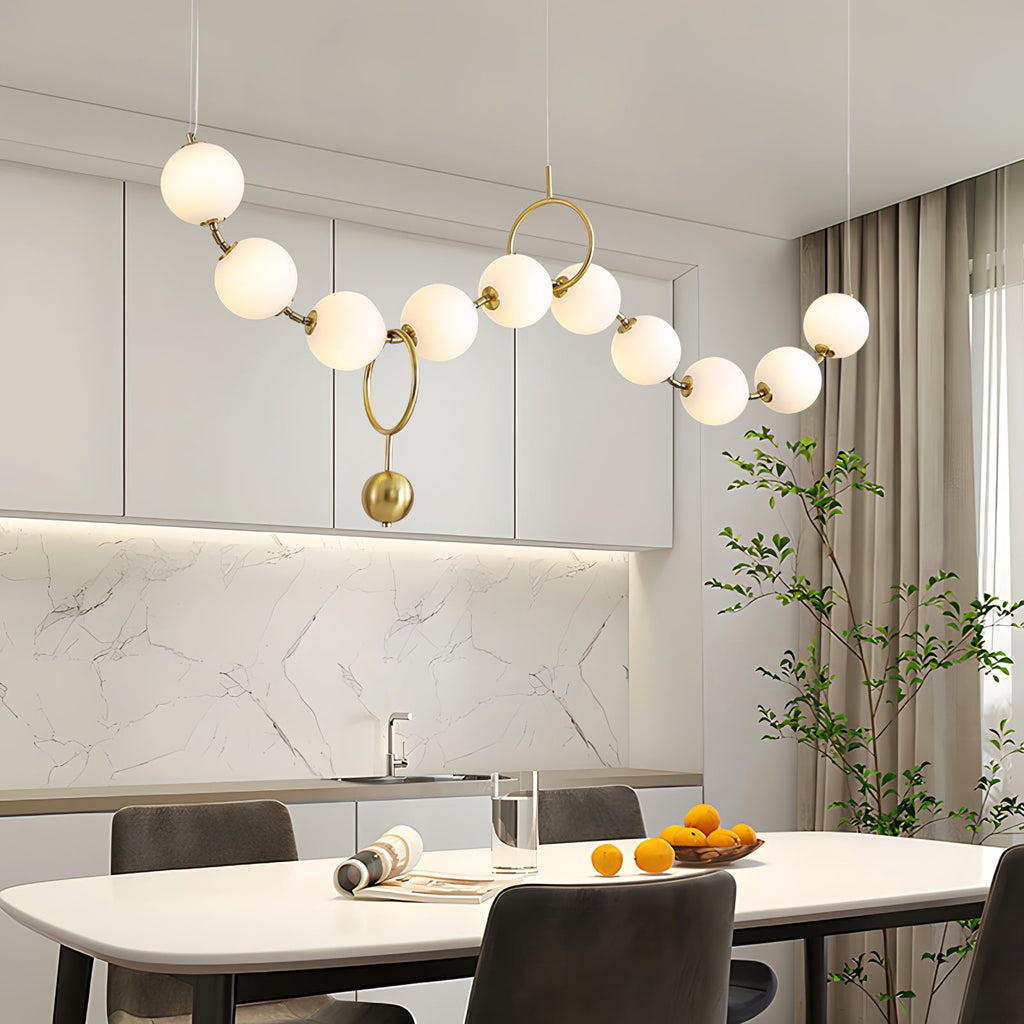 Necklace pendant light glowing softly over a table