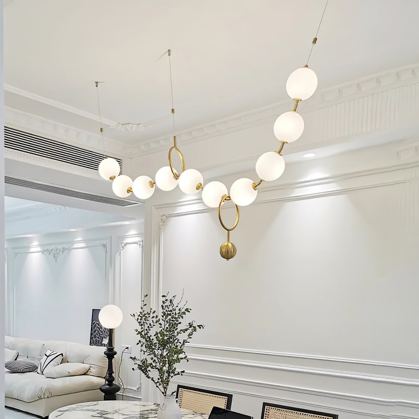 Hand-blown glass globe detail on the necklace pendant light