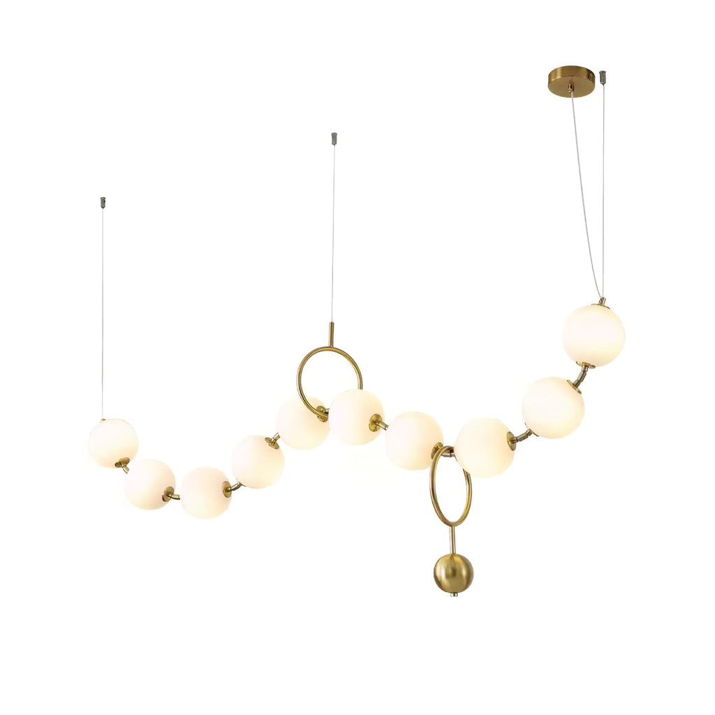 Necklace pendant light with white glass globes glowing warm