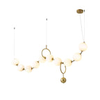 Necklace pendant light with white glass globes glowing warm