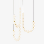Acrylic pearl chandelier styled above an elegant table setting