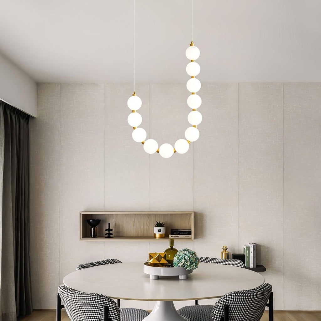 Acrylic pearl chandelier suspended as a soft pearl-glow centrepiece