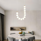 Acrylic pearl chandelier suspended as a soft pearl-glow centrepiece