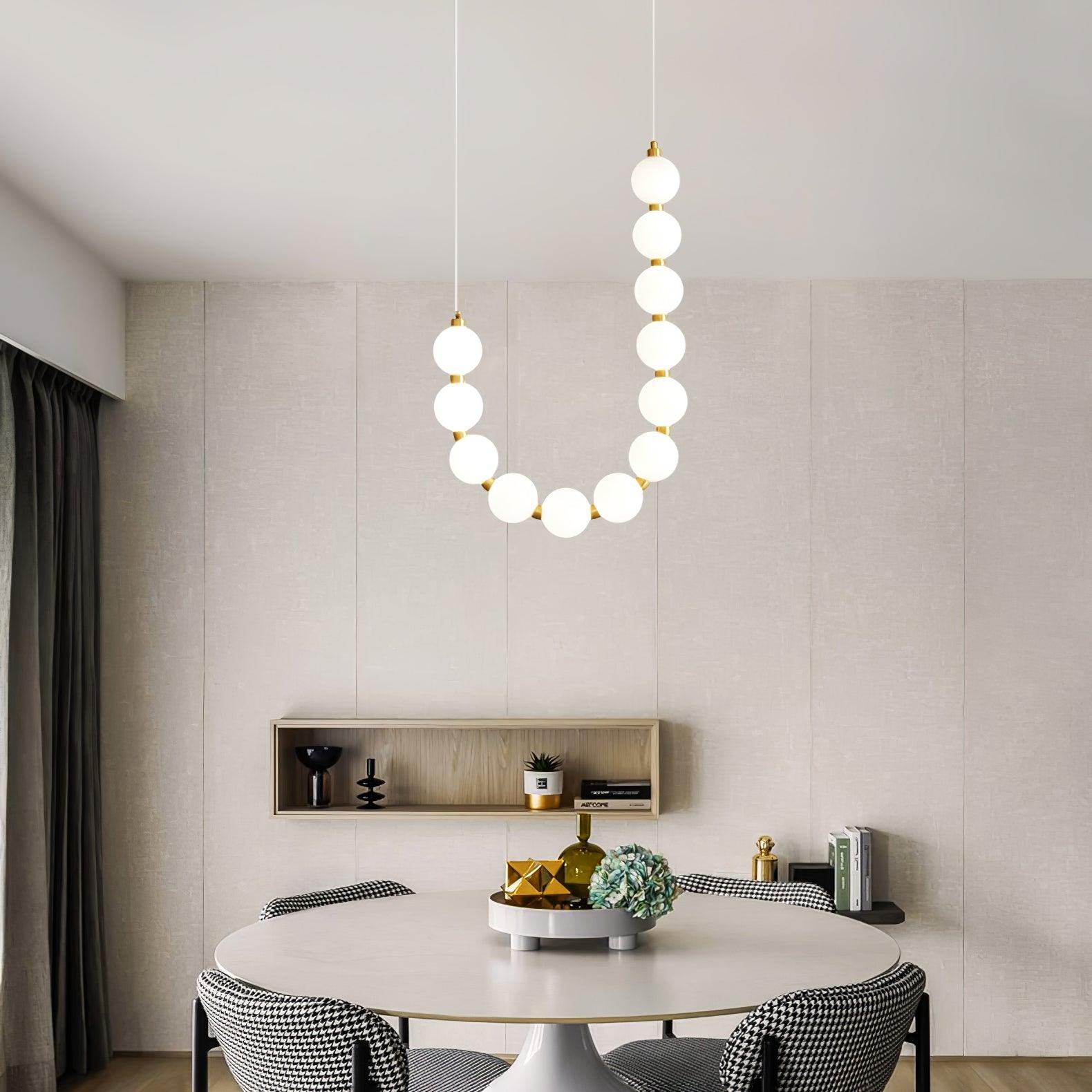 Acrylic pearl chandelier suspended as a soft pearl-glow centrepiece