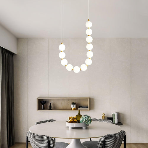 Acrylic pearl chandelier suspended as a soft pearl-glow centrepiece