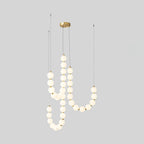 Acrylic pearl chandelier with brass frame and luminous orbs