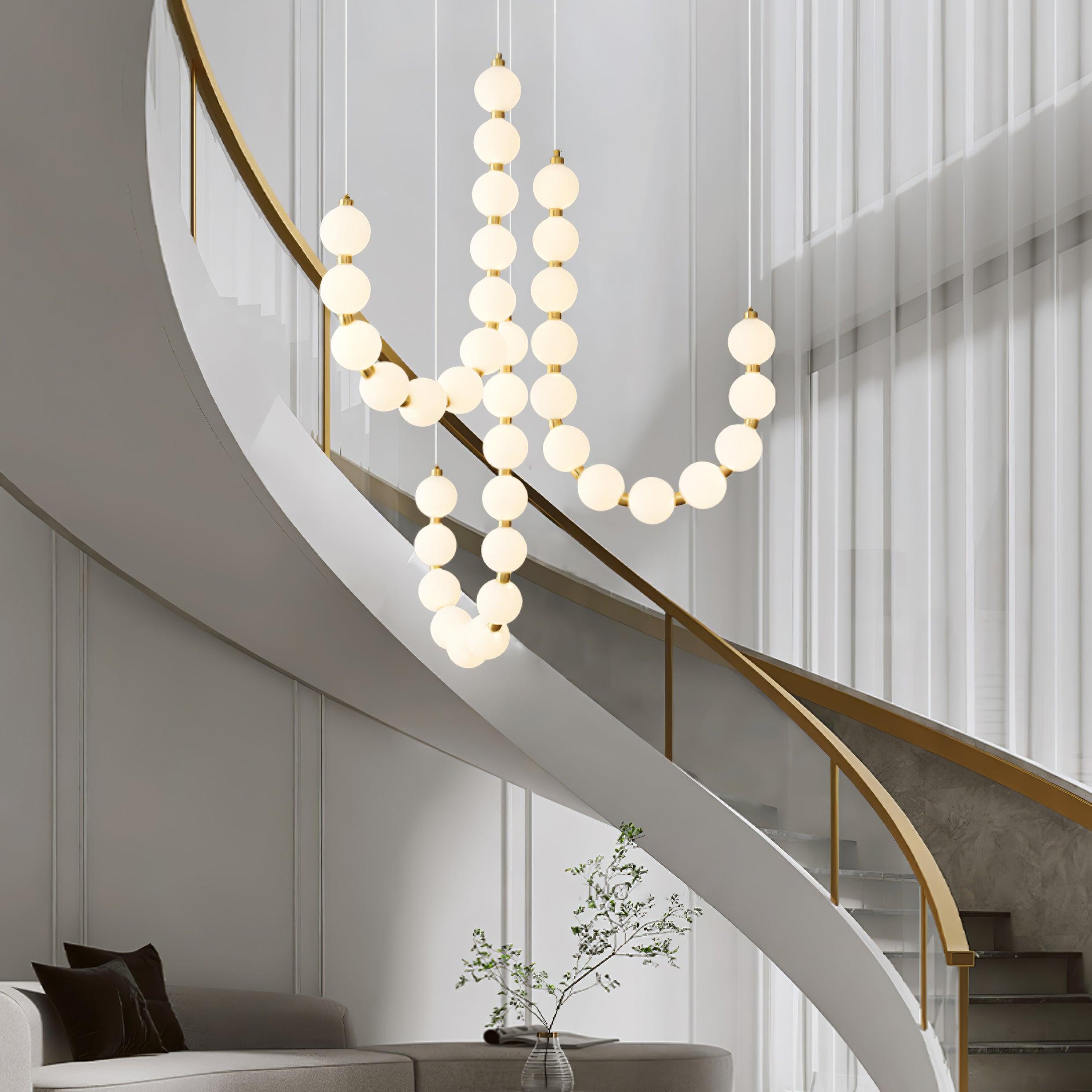 Acrylic pearl chandelier with brass frame and glowing white orbs