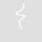 Acrylic pearl chandelier as a warm glowing dining centrepiece