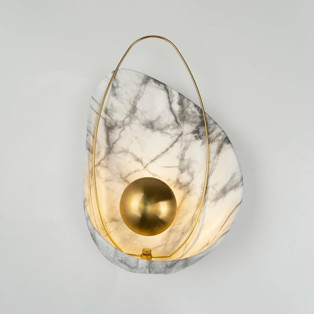 Lit sconce seen straight on, the brass hoop meeting a small collar fixing at the base of the shell.
