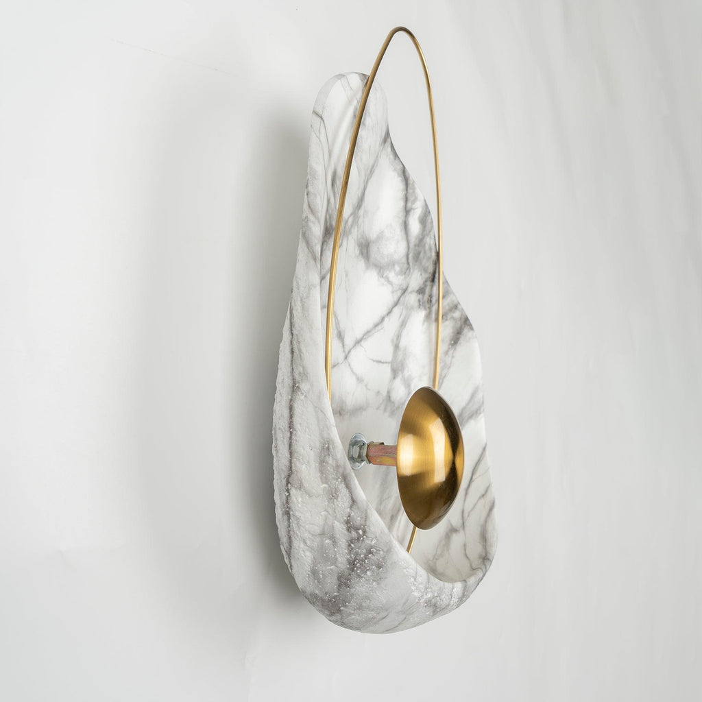 Side view of the unlit sconce, showing the orb on its short stem and the bolt fixing behind it.