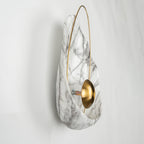 Side view of the unlit sconce, showing the orb on its short stem and the bolt fixing behind it.
