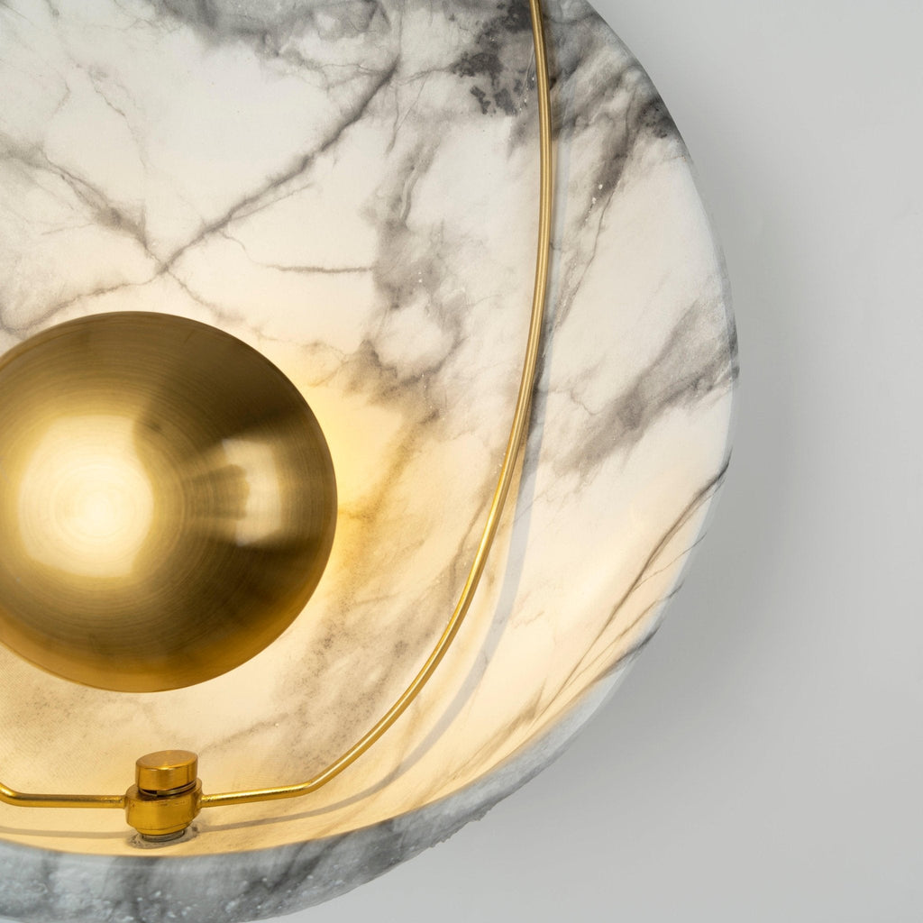 Close view of the lit shell from the lower left, the orb at the edge and the brass collar below.