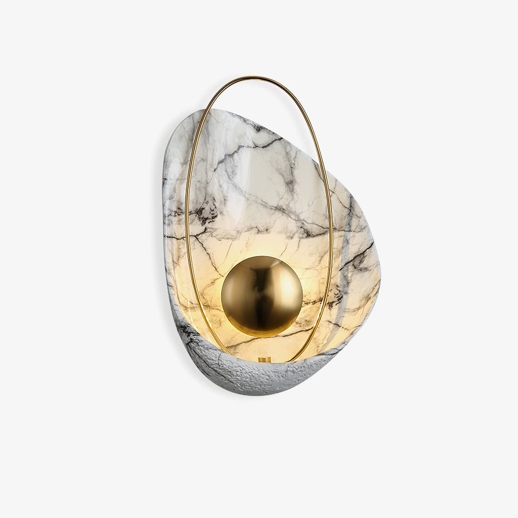 Marbled shell wall sconce in white, lit behind its brass orb, shown against a plain white ground.