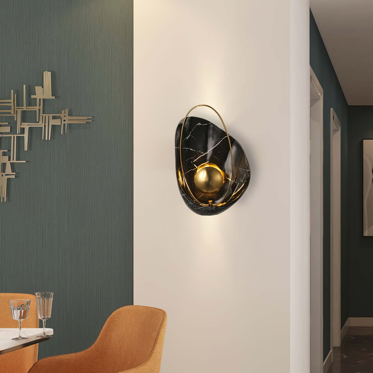 Black marbled sconce lit on a white hallway wall, throwing light up and down beside a teal room.