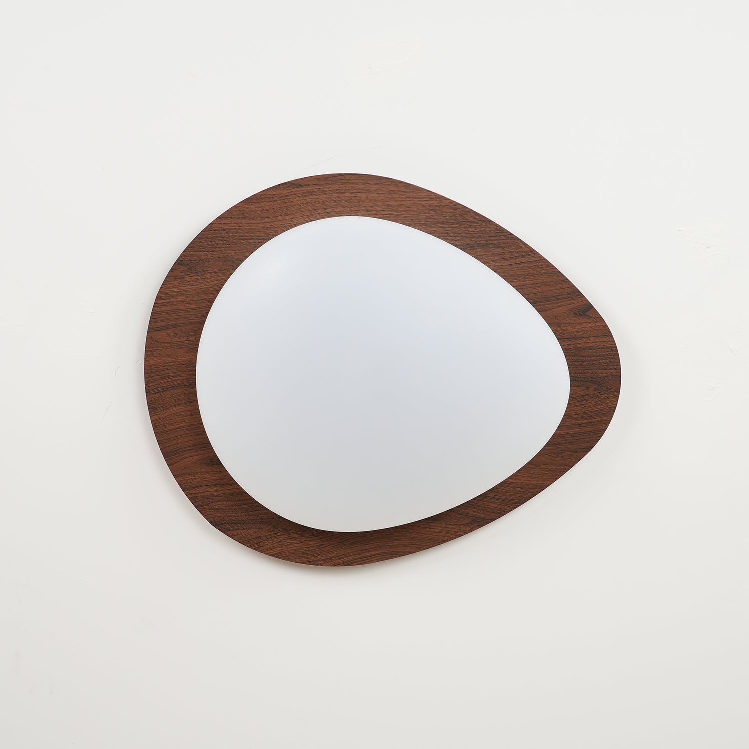 Walnut grain pebble ceiling light glowing softly overhead