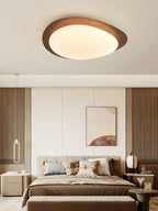 Pebble ceiling light with organic shape and warm glow