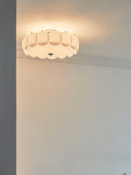 This Clérachic ceiling light glows warm in a corner beneath ornate crown moulding.
