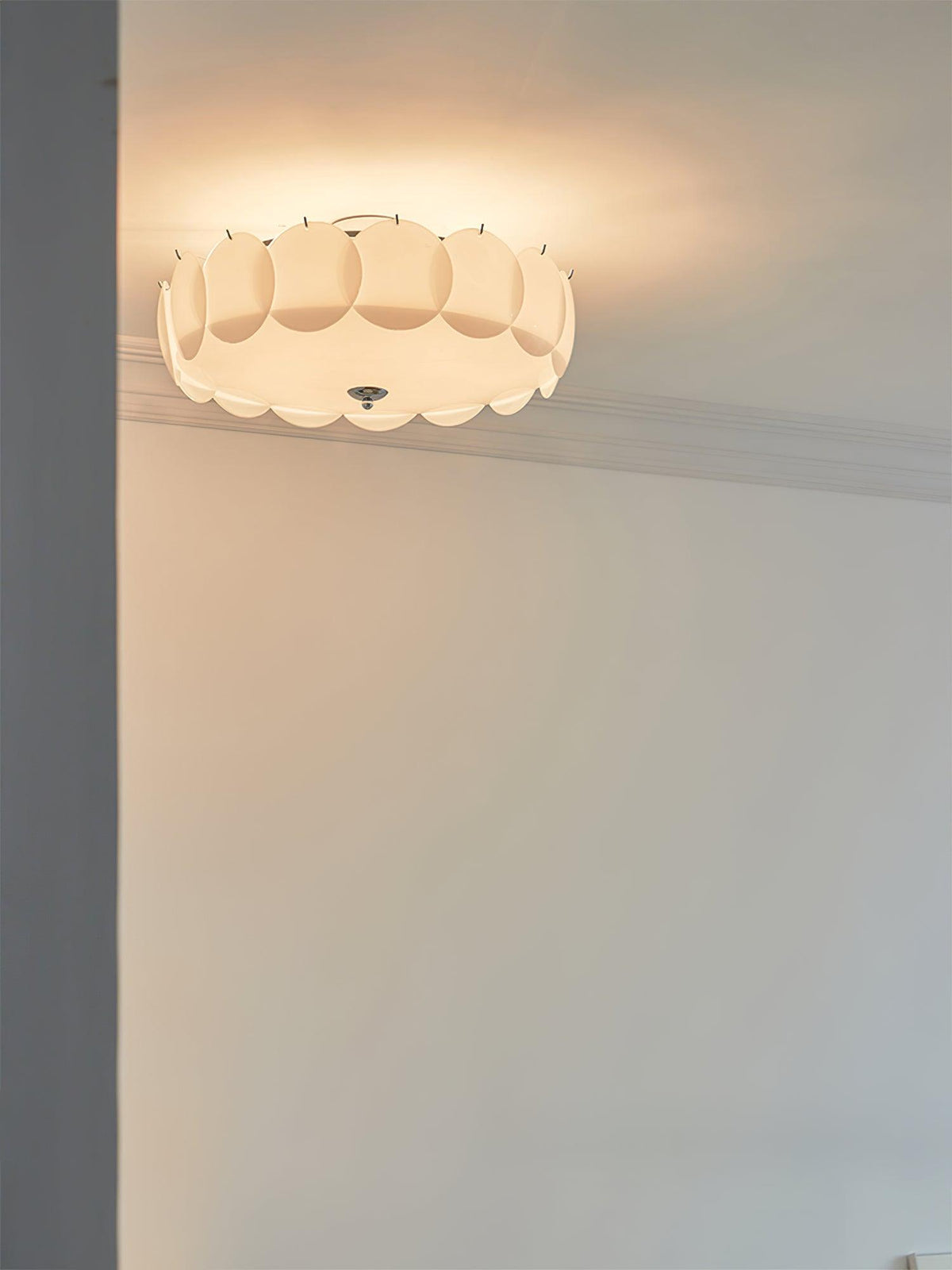 This Clérachic ceiling light glows warm in a corner beneath ornate crown moulding.