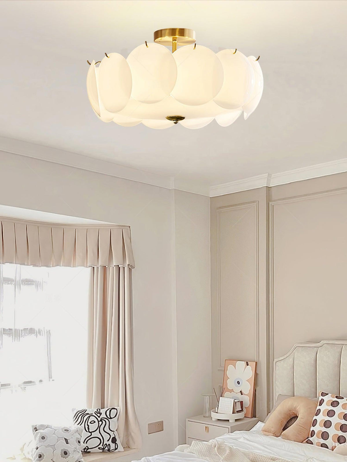 This Clérachic ceiling light glows warm in a bedroom corner, above a window dressed with soft pink curtains.