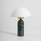 The green marble version of the Veviniel lamp, brass sphere joint visible between shade and stone column.