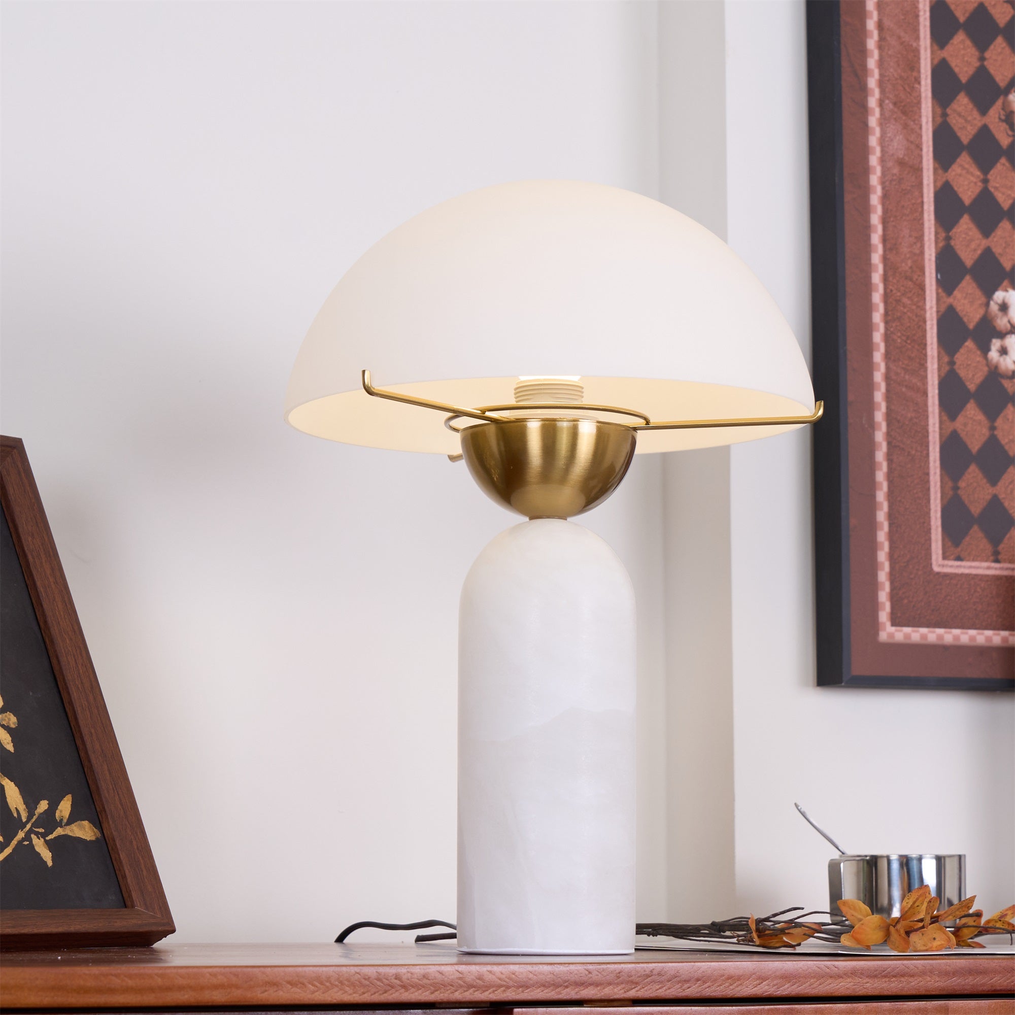Veviniel lamp on a wooden sideboard, viewed from above so the brass bowl and bulb socket under the shade show.