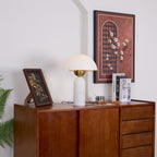 Veviniel lamp photographed close, the brass bowl and gold shade rim visible beneath the dome.