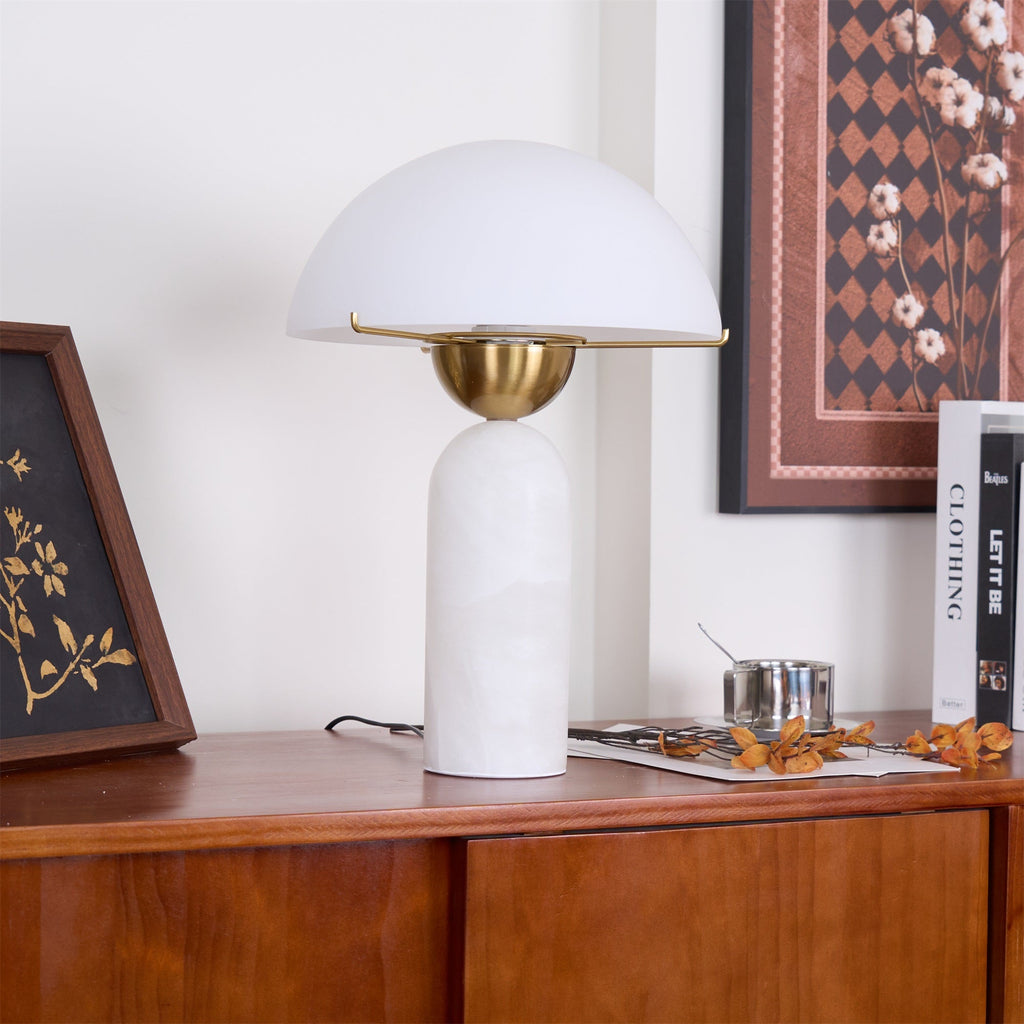 The Veviniel lamp on a wooden sideboard with the shade's underside and brass fitting in view.