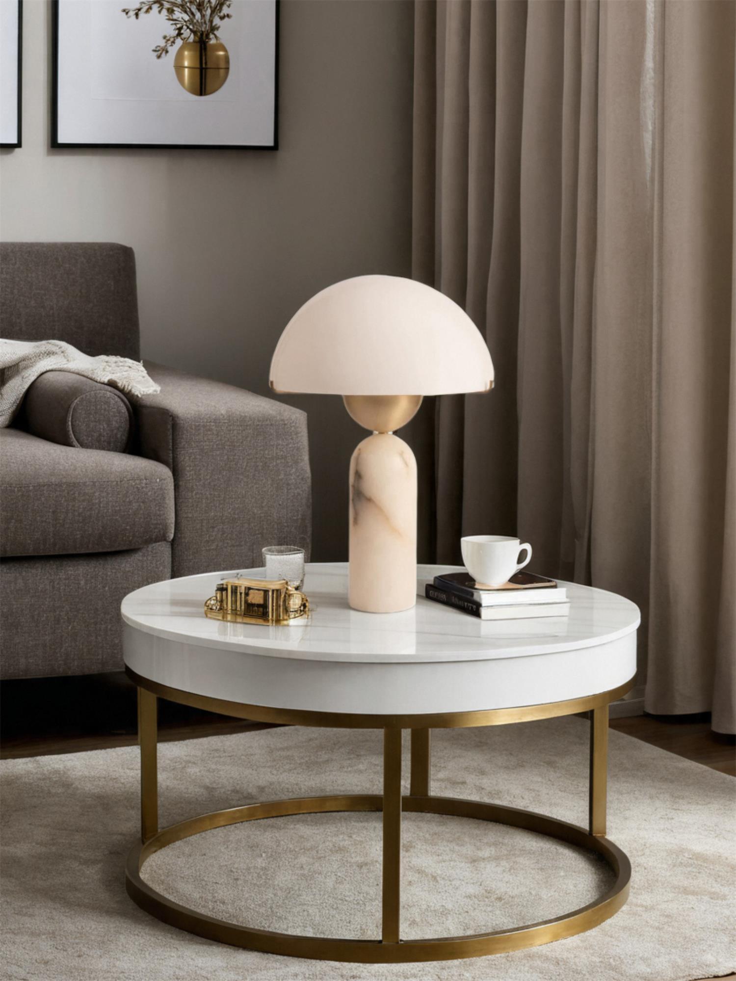 Veviniel lamp on a round marble coffee table in a living room, beside a cup and stacked books.