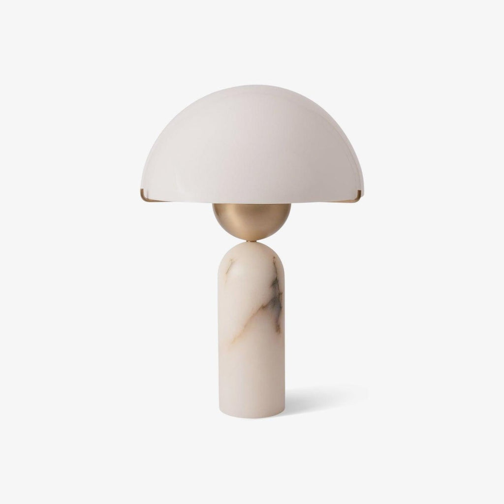 Front view of the Veviniel table lamp, its cream dome shade balanced on a brass sphere and pale alabaster column.