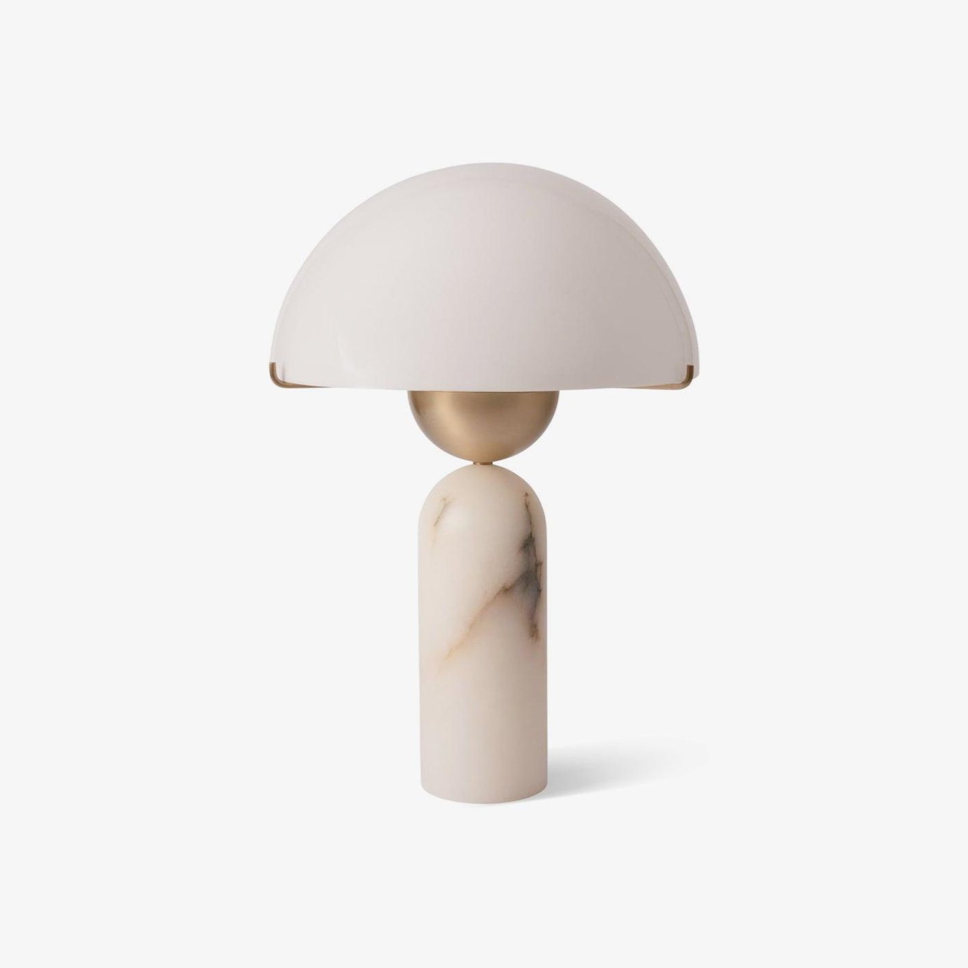 Front view of the Veviniel table lamp, its cream dome shade balanced on a brass sphere and pale alabaster column.