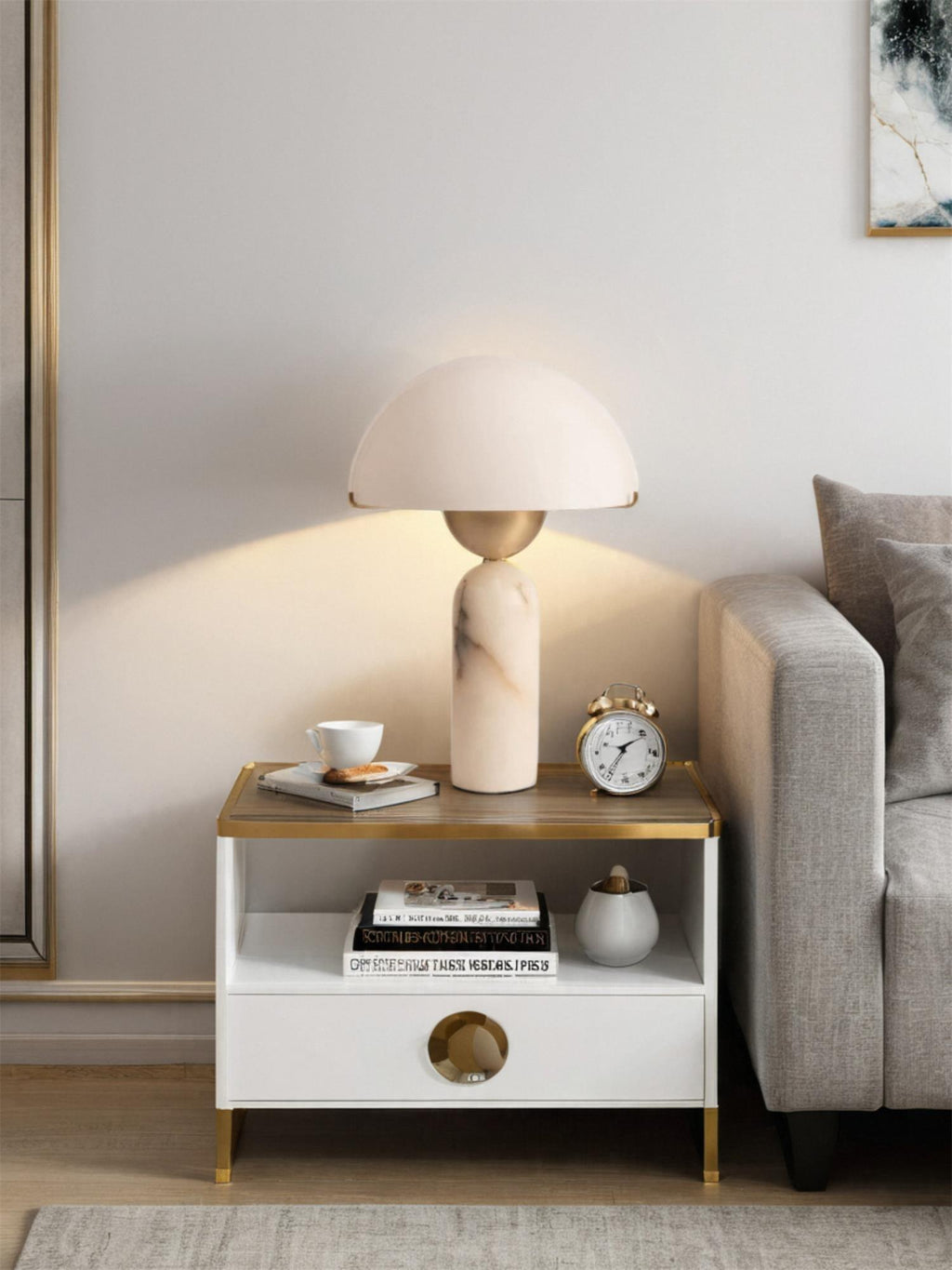Veviniel lamp lit on a two-tier side table by a sofa, glow fanning out across the wall.