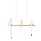 Bird chandelier branch detail with a small perched acrylic bird