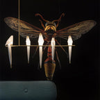 Bird chandelier with gold frame suspended in a bright room