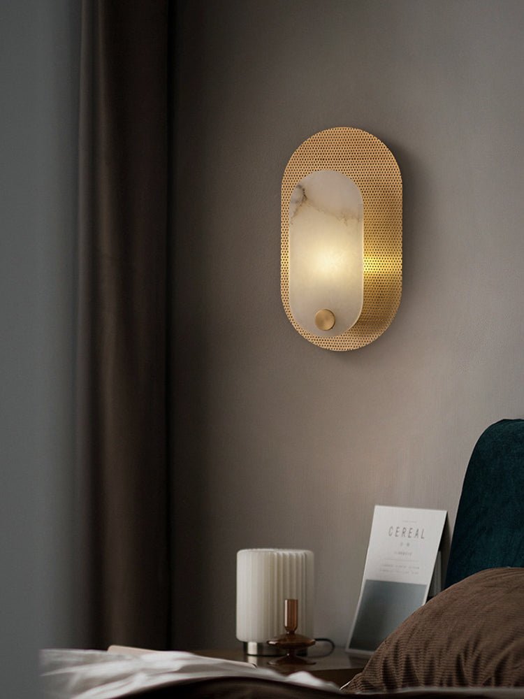 A closer view of the same bedroom scene, the punched brass plate catching the light.