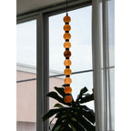 Overlooking nearby rooftops, this Clérachic alabaster sphere pendant glows warm against the window.