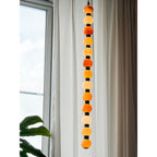 This Clérachic pendant's pale alabaster spheres hang against a bright window and sheer curtain.