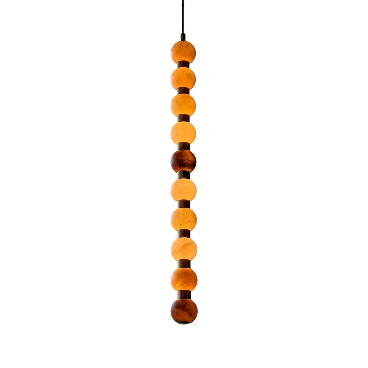 Photographed on white, this Clérachic pendant's alabaster spheres shift from amber to brown.