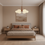 This Clérachic chandelier lights a bedroom with a terracotta landscape print centred above the headboard.