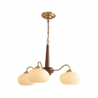 Full length against white, this Clérachic chandelier's three cream shades hang from a dark walnut pole.