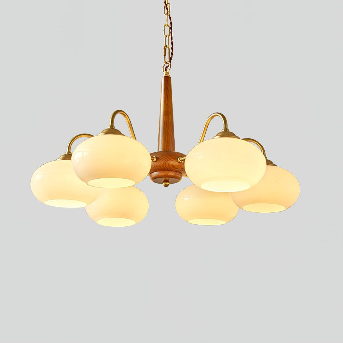 Six cream shades on this Clérachic chandelier are shown fully lit against a plain grey background.