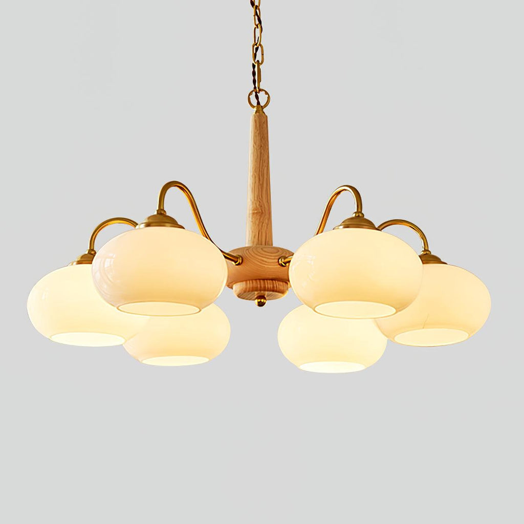 On a plain grey backdrop, this Clérachic chandelier shows its pale wood pole and six lit cream shades.