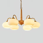 On a plain grey backdrop, this Clérachic chandelier shows its pale wood pole and six lit cream shades.